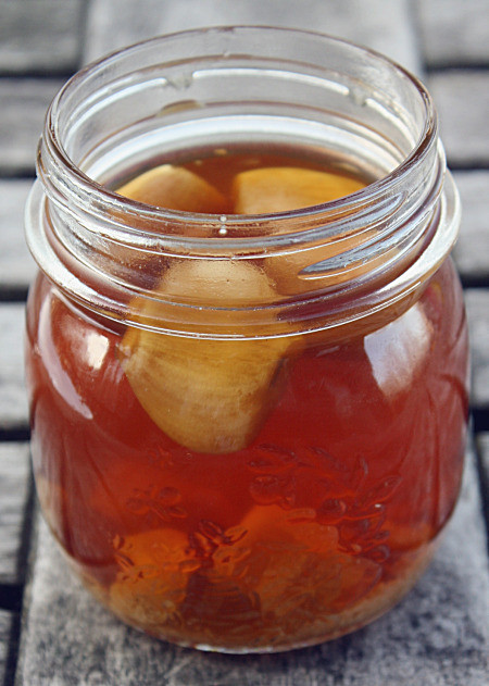 Garlic cloves in a jar of honey