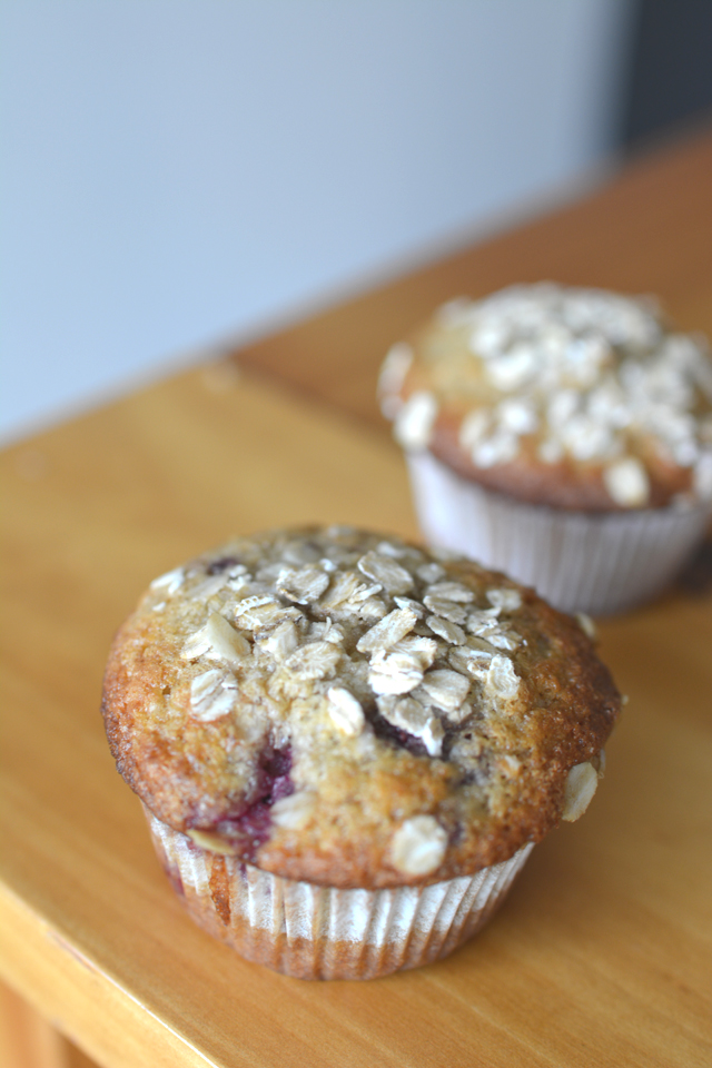 image of two delicious Raspberry and Coconut Muffins with a generous topping of rolled oats