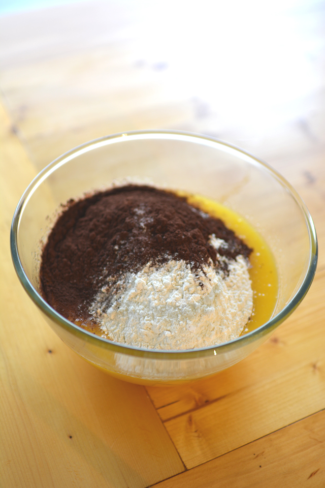 mixing bowl containing butter, cocoa powder, and flour