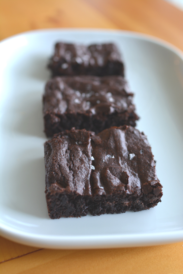 an image of three sliced salted chocolate brownies arranged on a plate.