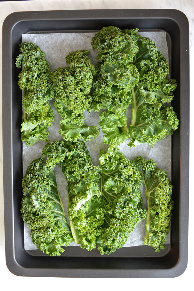 a bunch of fresh kale leaves in a baking tray 