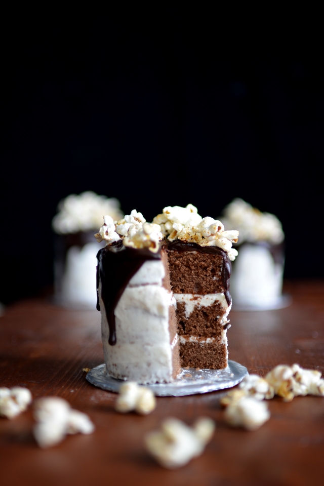 close-up top view of a chocolate cake with chili lime popcorn, highlighting a sliced section of the entire cake