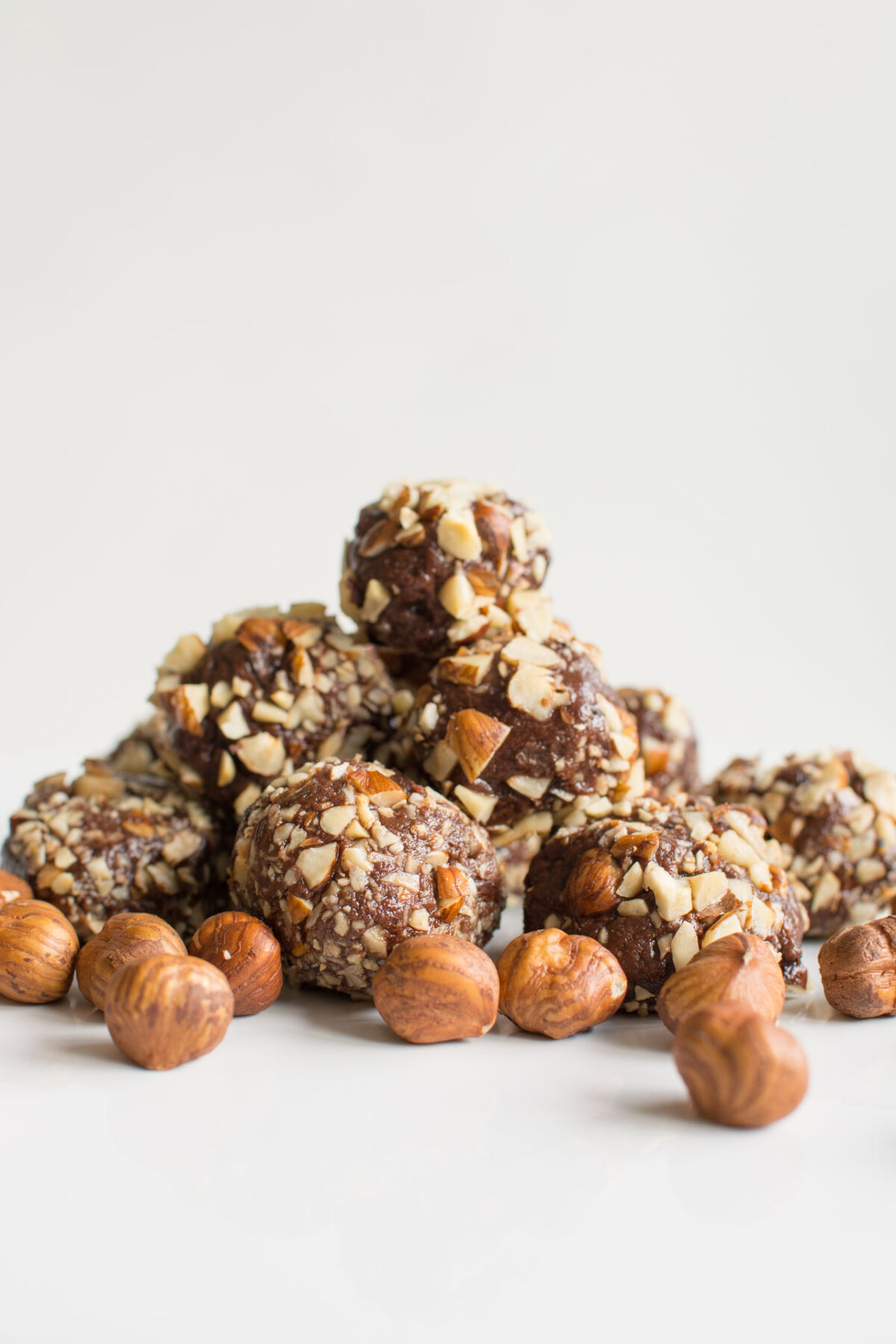 close up view imagae of nutella truffles with some hazelnuts 
