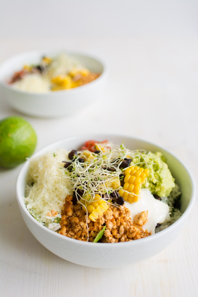 close up image of a bowl of sofritas style burrito with tofu lime rice and grilled corn