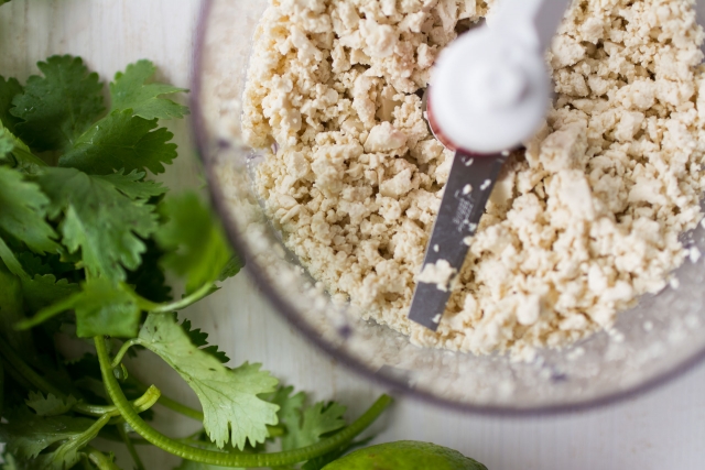 Small Bunch of Coriander and basmati rice with lime in a grinder