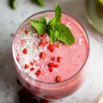 A raspberry smoothie garnished with mint.