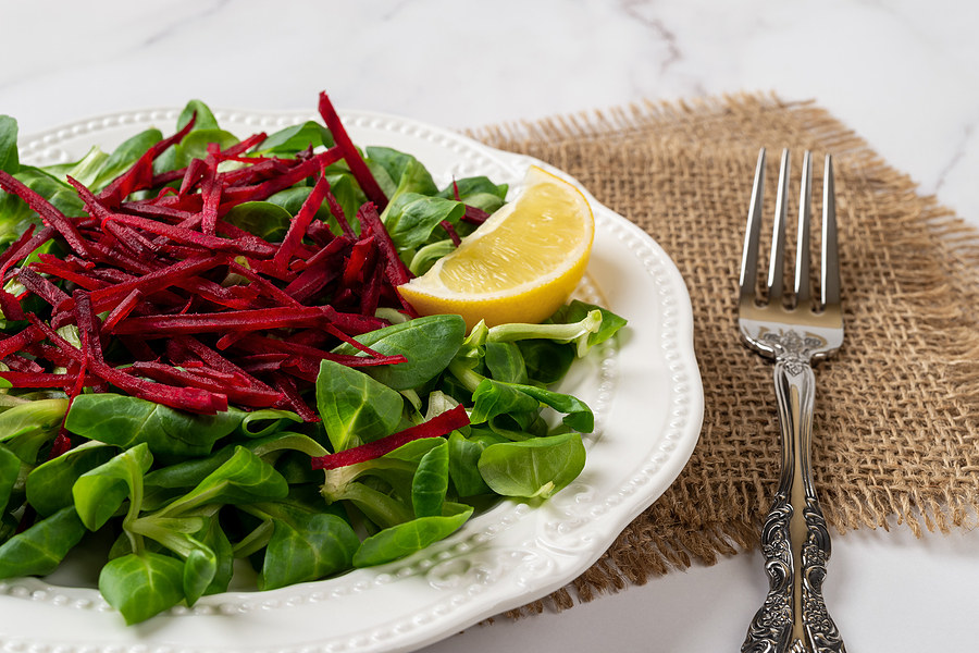 Beets cut into matchstick shapes over lettuce.