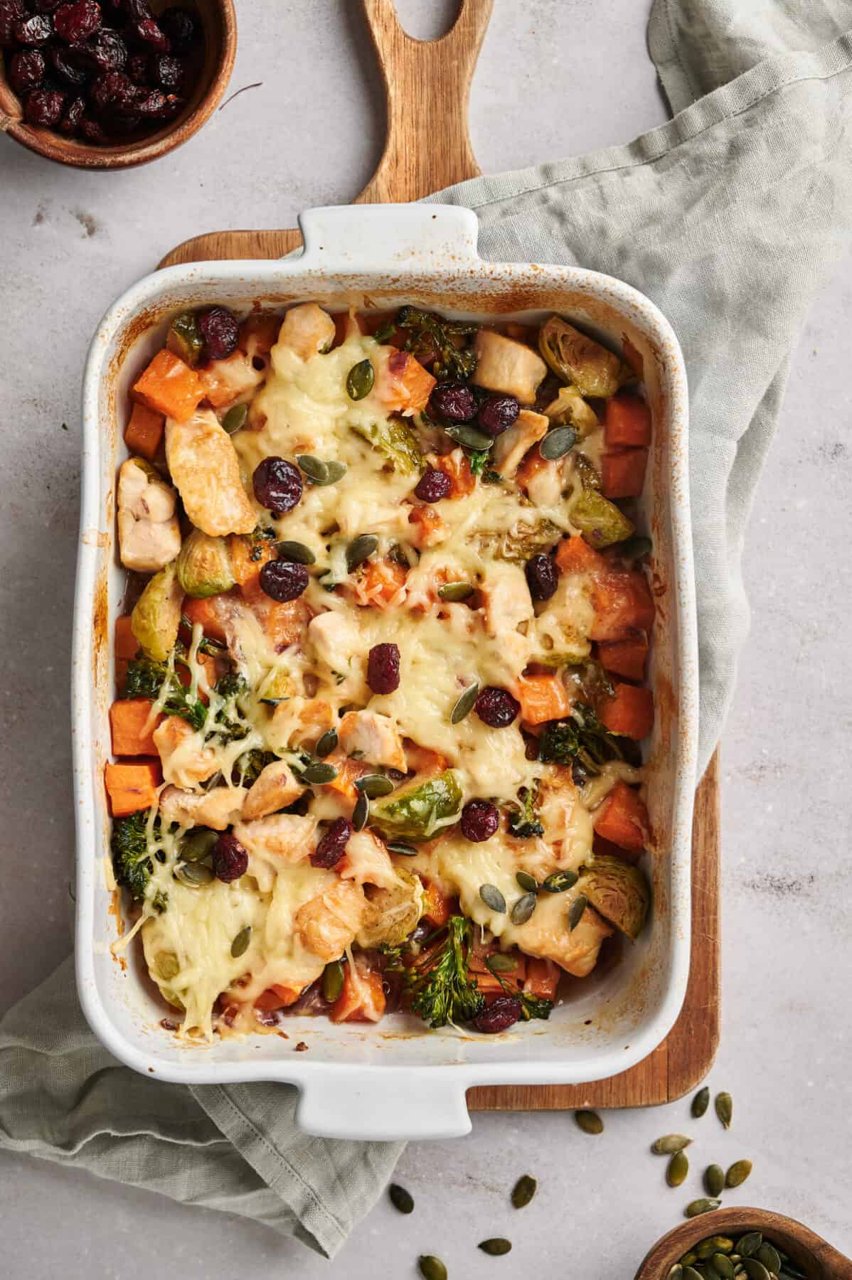Harvest Chicken Casserole, fresh from the oven on top of a wooden cutting board.