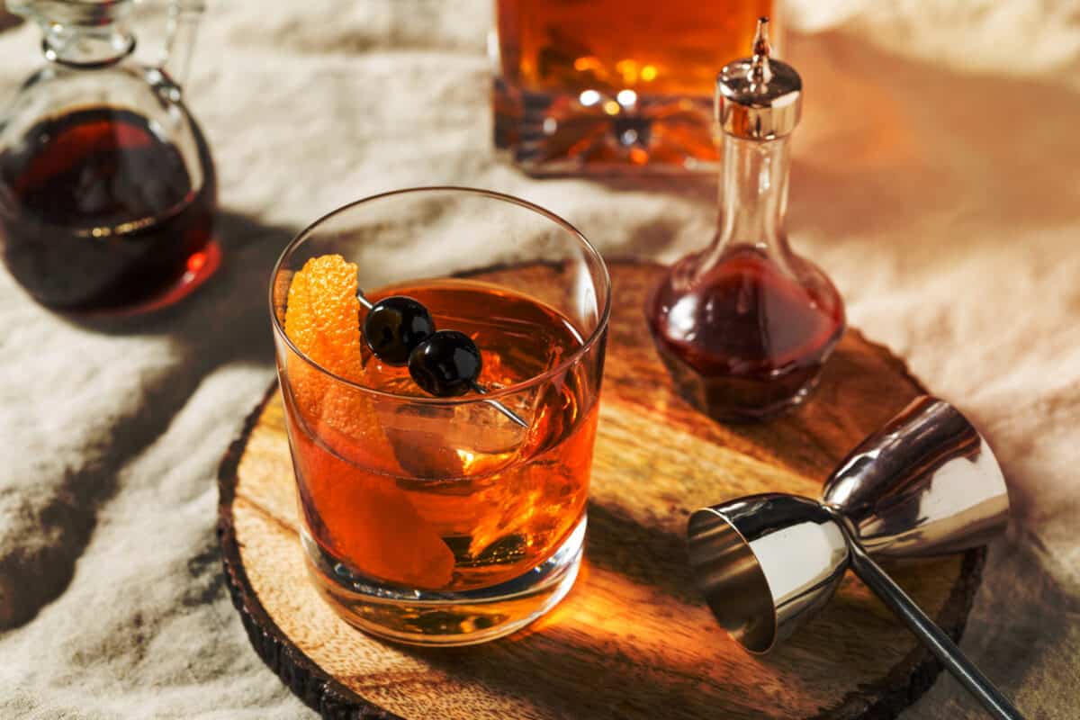 Boozy Maple Syrup Old Fashioned Cocktail with Bourbon and Cherries.