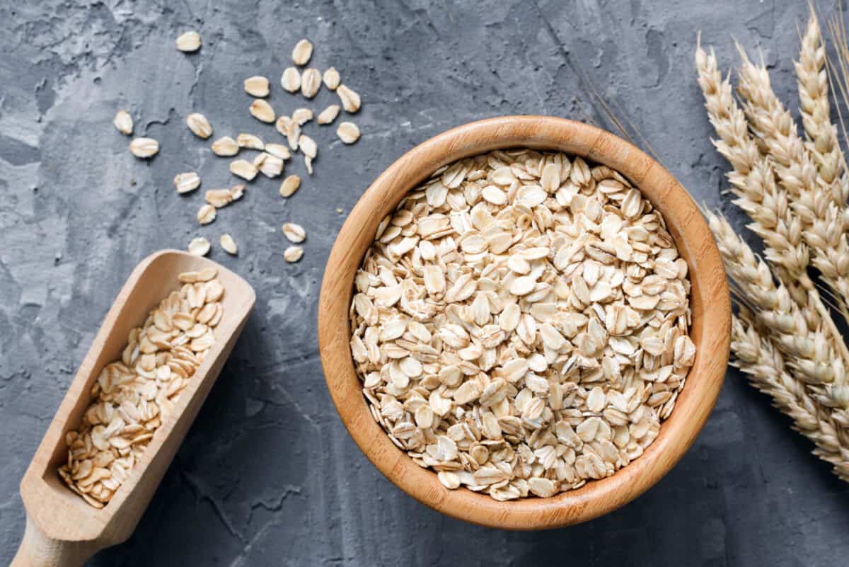 A bowl of old-fashioned rolled oats with a scoop.